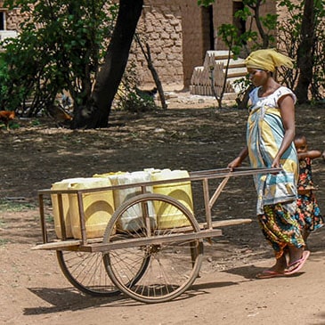 Water: Carrying the Burden - Woman Carting Water Containers