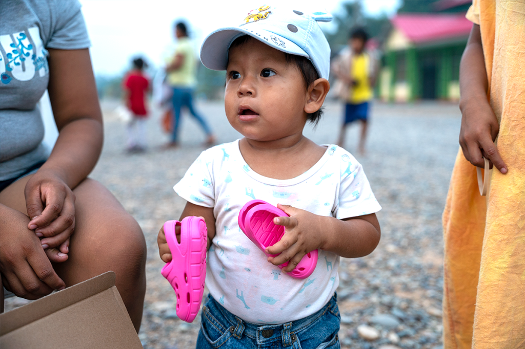 Child clings to new pair of pink shoes