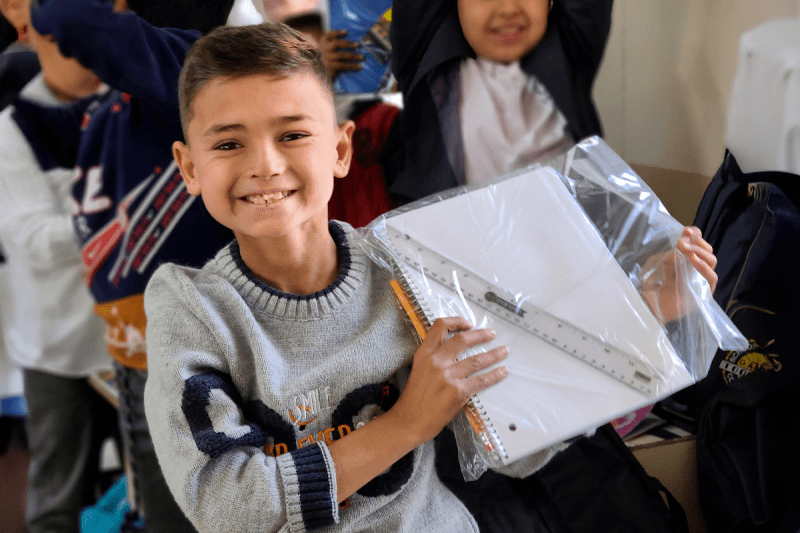 Copy of JordanM – School supplies dist. in Iraqi IDP camp-inblog Boy in Iraq receives school supplies