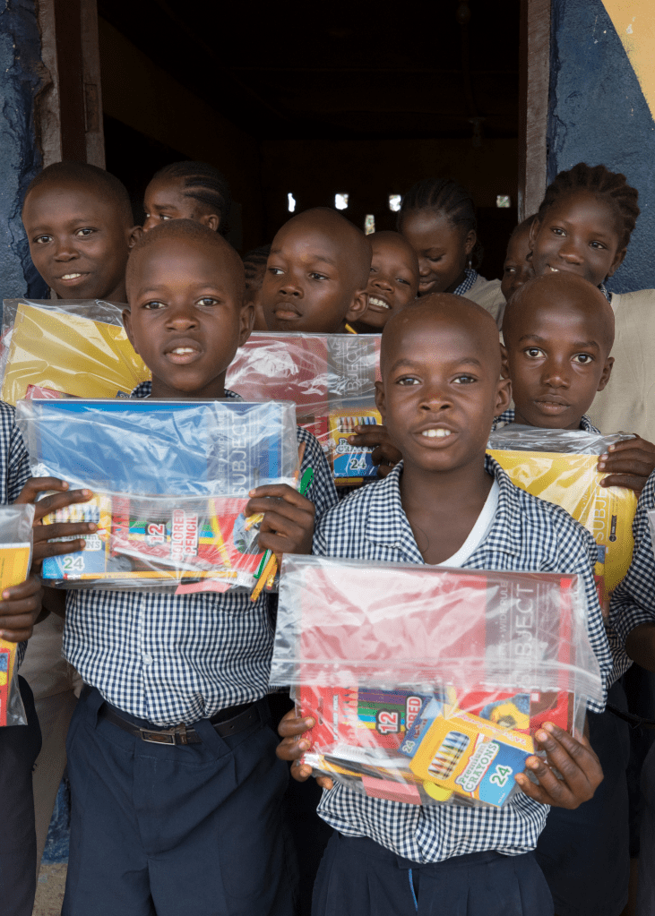 children holding school supplies