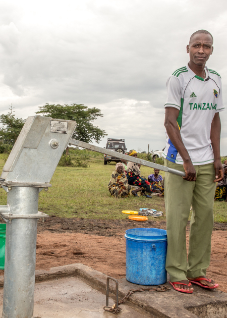 Churchplant-landingpg-main-photo Man stands beside water well