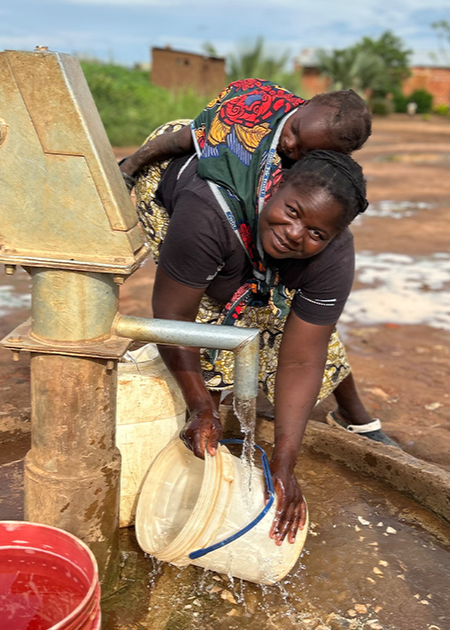 woman and baby at well